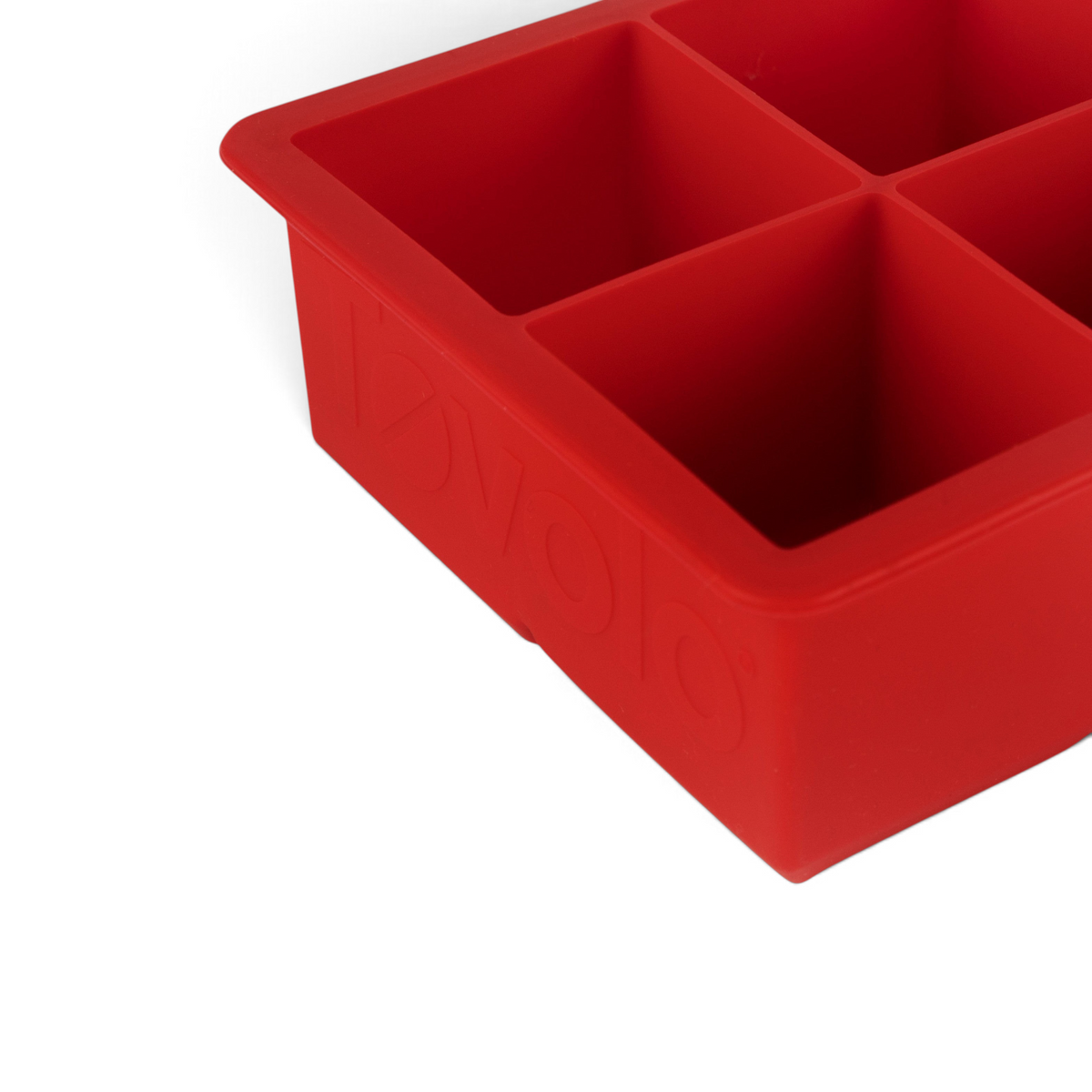 A close-up of the tovolo King Cube Silicone Ice Molds (Set of 2), featuring four large square compartments for craft ice or oversized cubes, shown from an angle.