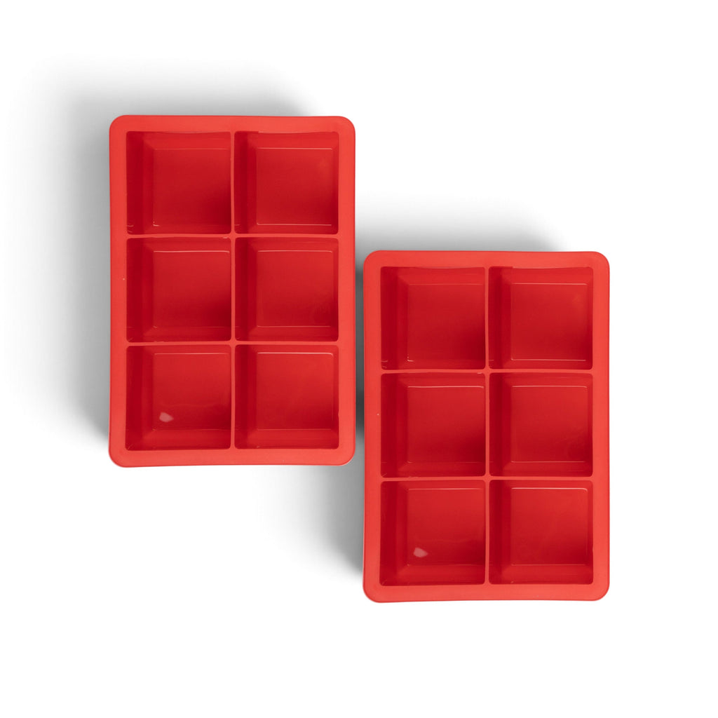 The tovolo King Cube Silicone Ice Molds (Set of 2) feature six large square compartments each, perfect for making craft ice cubes. The red trays are set against a white background, ideal for creating large ice cubes at home.