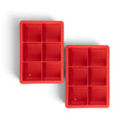 The tovolo King Cube Silicone Ice Molds (Set of 2) feature six large square compartments each, perfect for making craft ice cubes. The red trays are set against a white background, ideal for creating large ice cubes at home.
