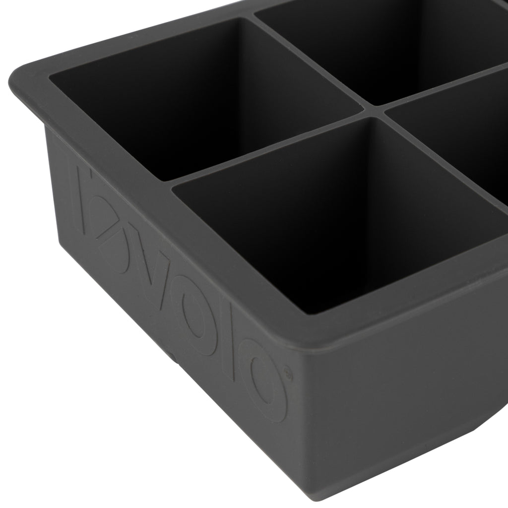 A close-up of the tovolo King Cube Silicone Ice Molds (Set of 2) in black, featuring four large square compartments and the brand name embossed on the side.