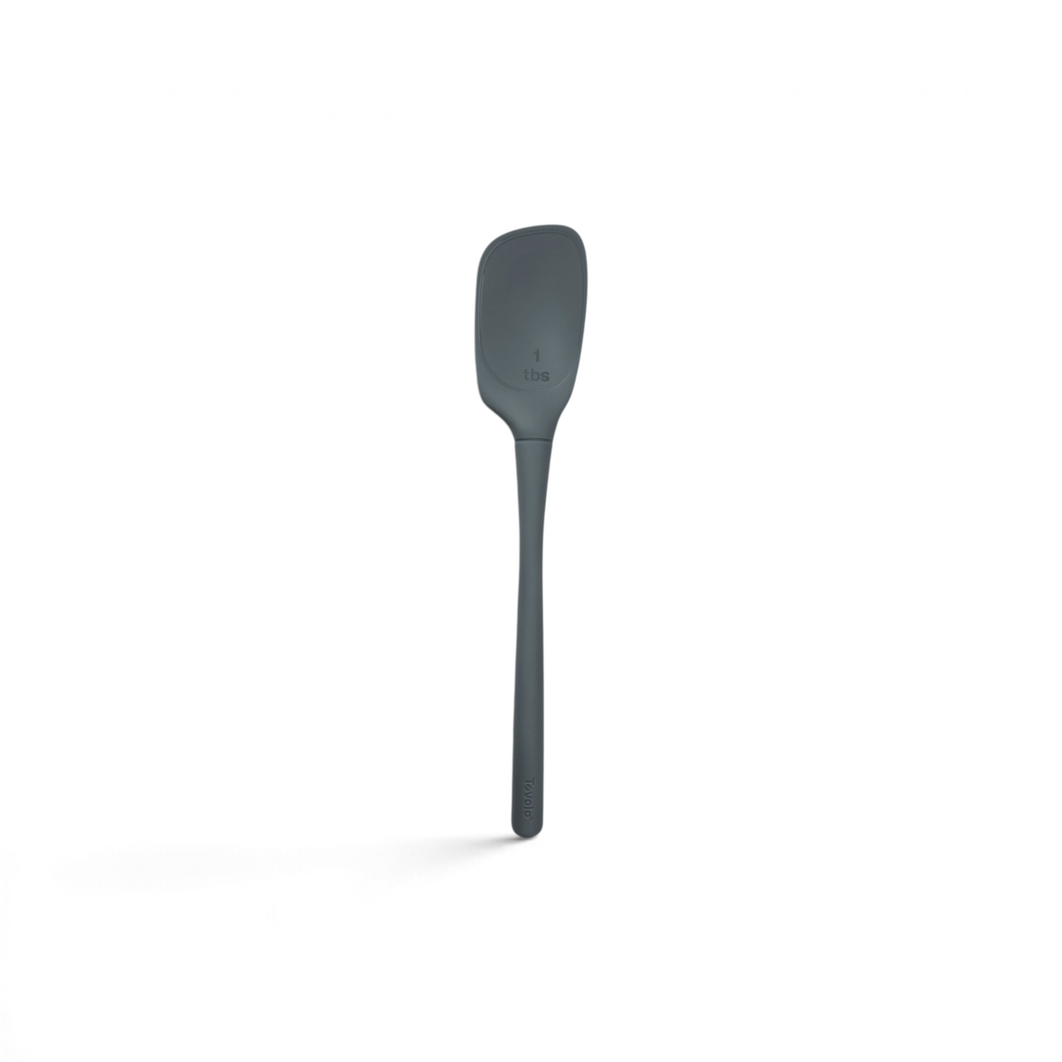The tovolo Flex-Core Silicone Deep Spoonula, shown on a white background, is a gray, heat-resistant kitchen tool featuring a 1-tablespoon measurement marked on its head.