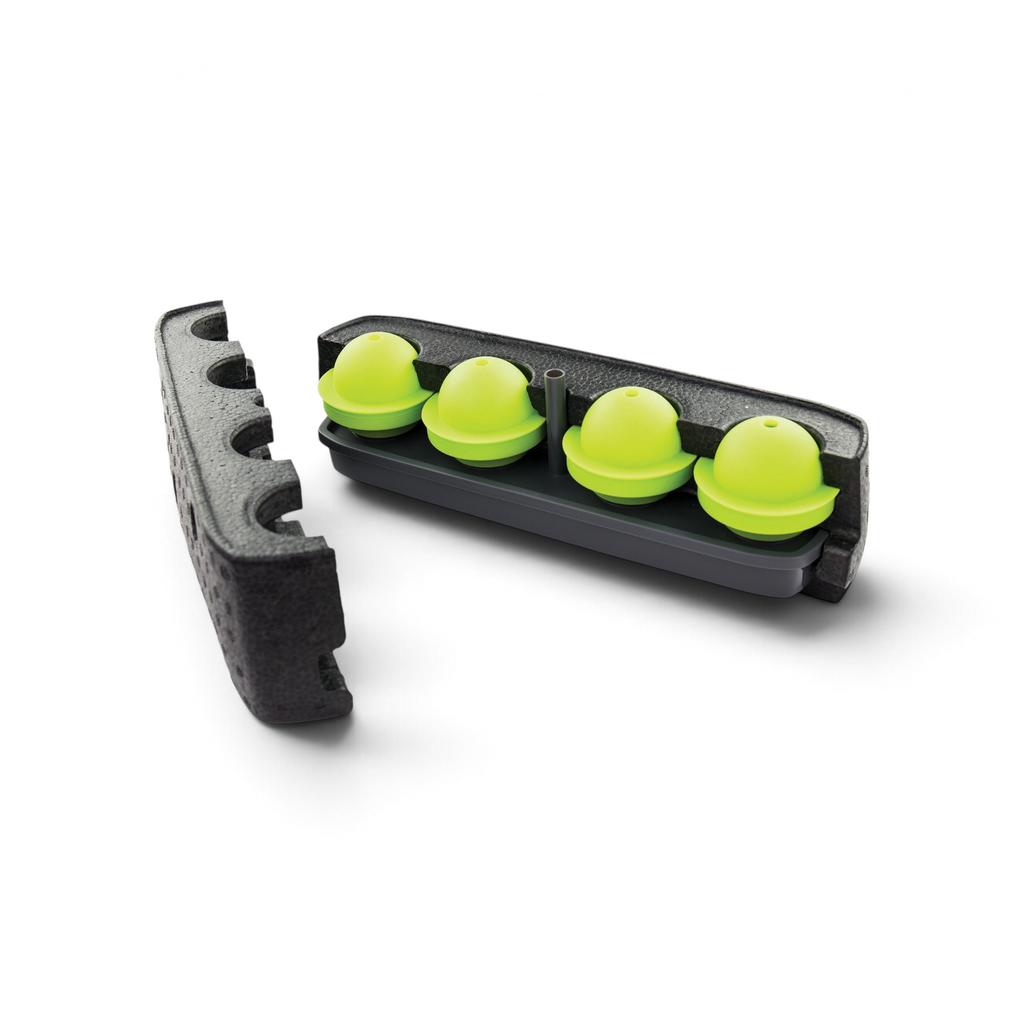 The Sphere Clear Ice Mold features a black foam container with an ice tray that creates four bright green, dome-shaped spheres. Its lid, designed for easy freezer stacking, is shown resting to one side.