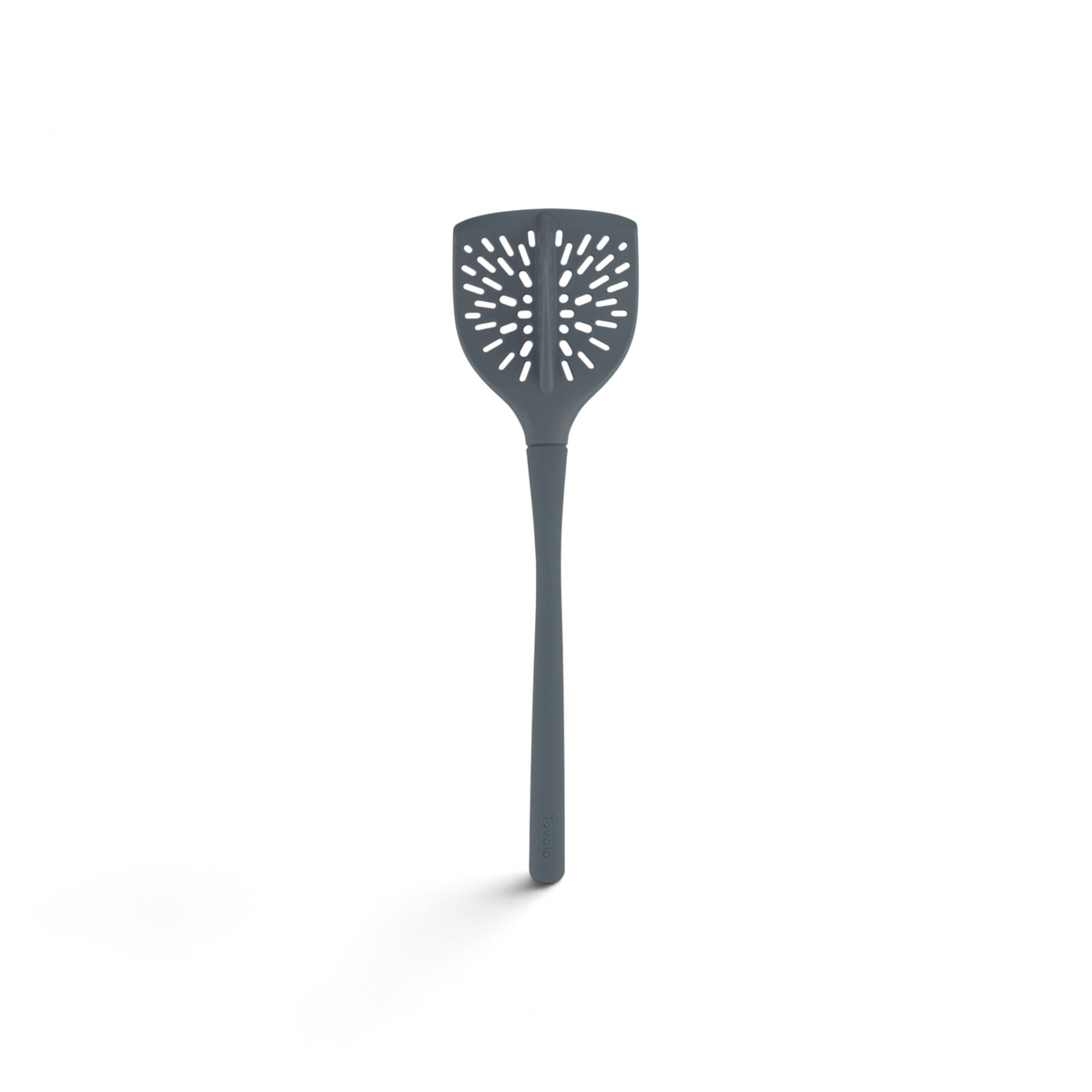 The Ground Meat Tool is a gray silicone utensil with a long handle and oval, vented head, designed for safe non-stick flipping and draining of food.