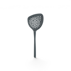 The Roasted Veggie Tool is a gray turner with a long handle and wide triangular head, featuring starburst holes for draining—ideal for serving roasted vegetables.