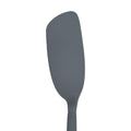 The Flipping Flex Turner is a gray silicone spatula with a slightly curved, smooth blade and a sturdy steel handle, perfect for nonstick cookware, shown isolated on a white background.