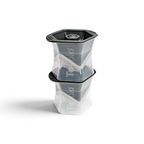 Two stacked tovolo Colossal Ice Molds (Set of 2) in clear and dark gray create large, geometric, slow-melting ice cubes. Each mold features the tovolo logo on the side.