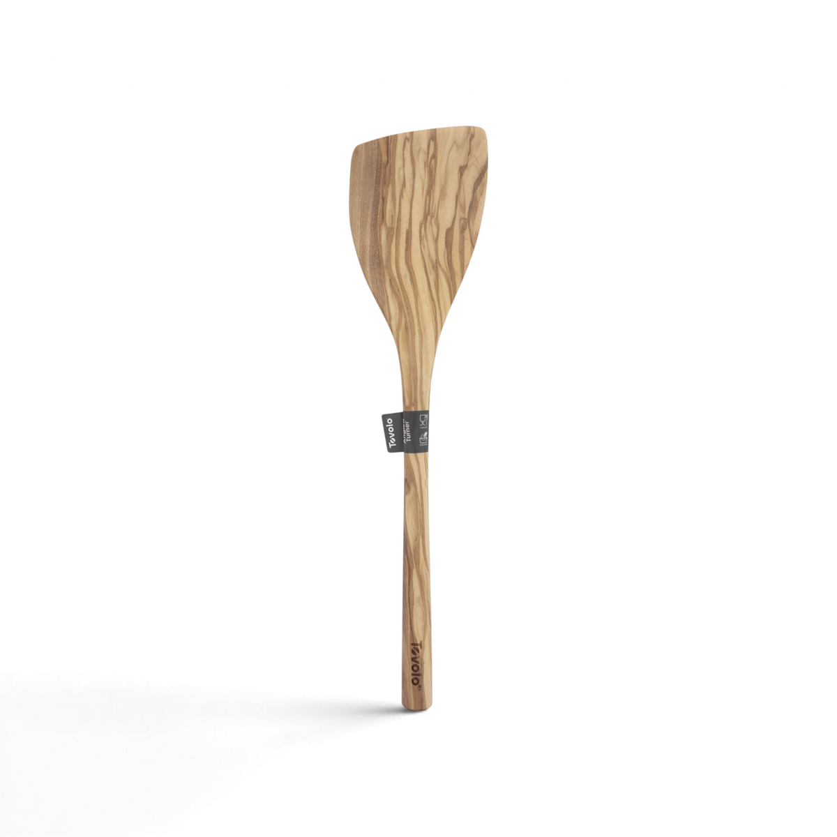 The Olivewood Utensils feature a flat, angled head and long handle, with a natural wood grain and a small label. This nonstick-safe olivewood spatula doubles as an elegant pancake turner.