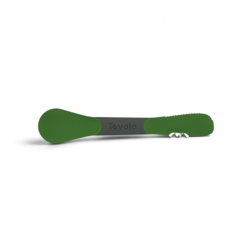 The 3-in-1 Avocado Tool features a green and gray design, textured handle, rounded spoon end, and a small metal blade. "Tovolo" is printed at the center.