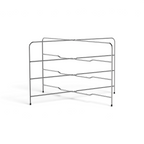 The Stack N Cool Baking Sheet Rack features three horizontal metal shelves in a zigzag design, supported by four legs with black rubber caps. Its open, minimalist style offers compact storage or cooling for trays, pans, and bakeware.