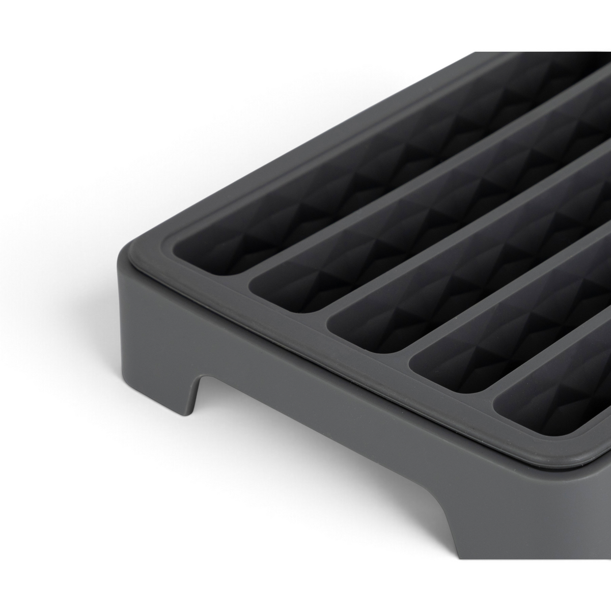 Close-up of the Water Bottle Ice Mold, featuring parallel, rectangular grooves and a raised edge—perfect for making ice cubes that fit water bottles or for organizing small items.