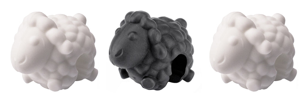 The Lid Lifters set includes three sheep-shaped silicone kitchen accessories—two white and one black, each with a side hole—displayed against a white background.
