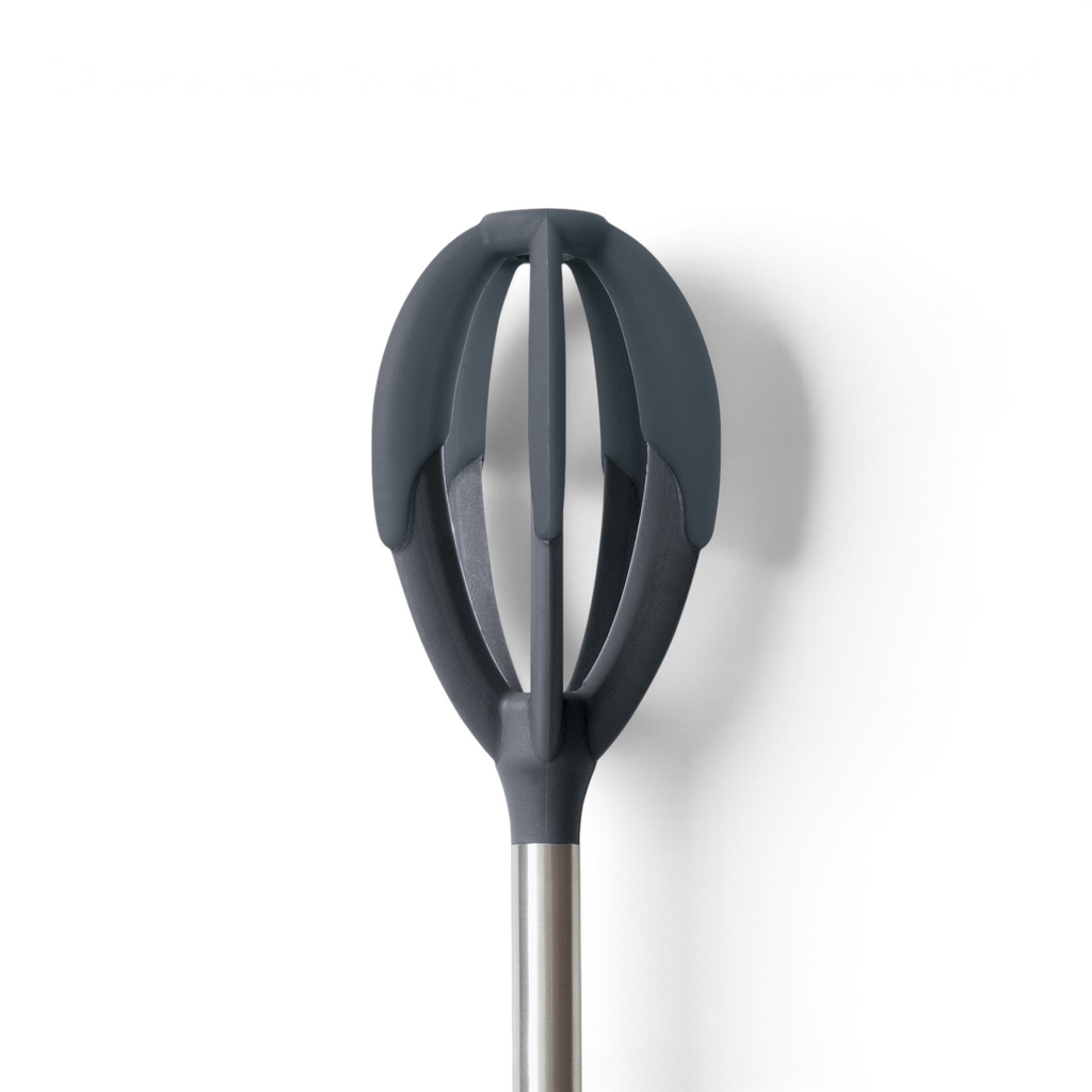 A close-up of the Better Batter Tool—a modern whisk with dark gray, oval silicone blades and a stainless steel handle—appears against a white background, ideal for mixing batters.